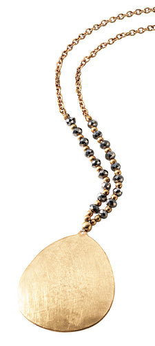 Long gold beaded chain with large gold metal disc pendant